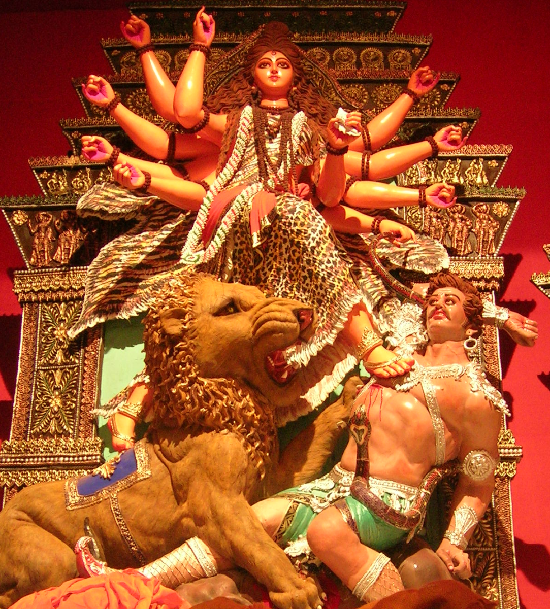 Goddess Durga riding on her lion and attacking demon Mahisasur.