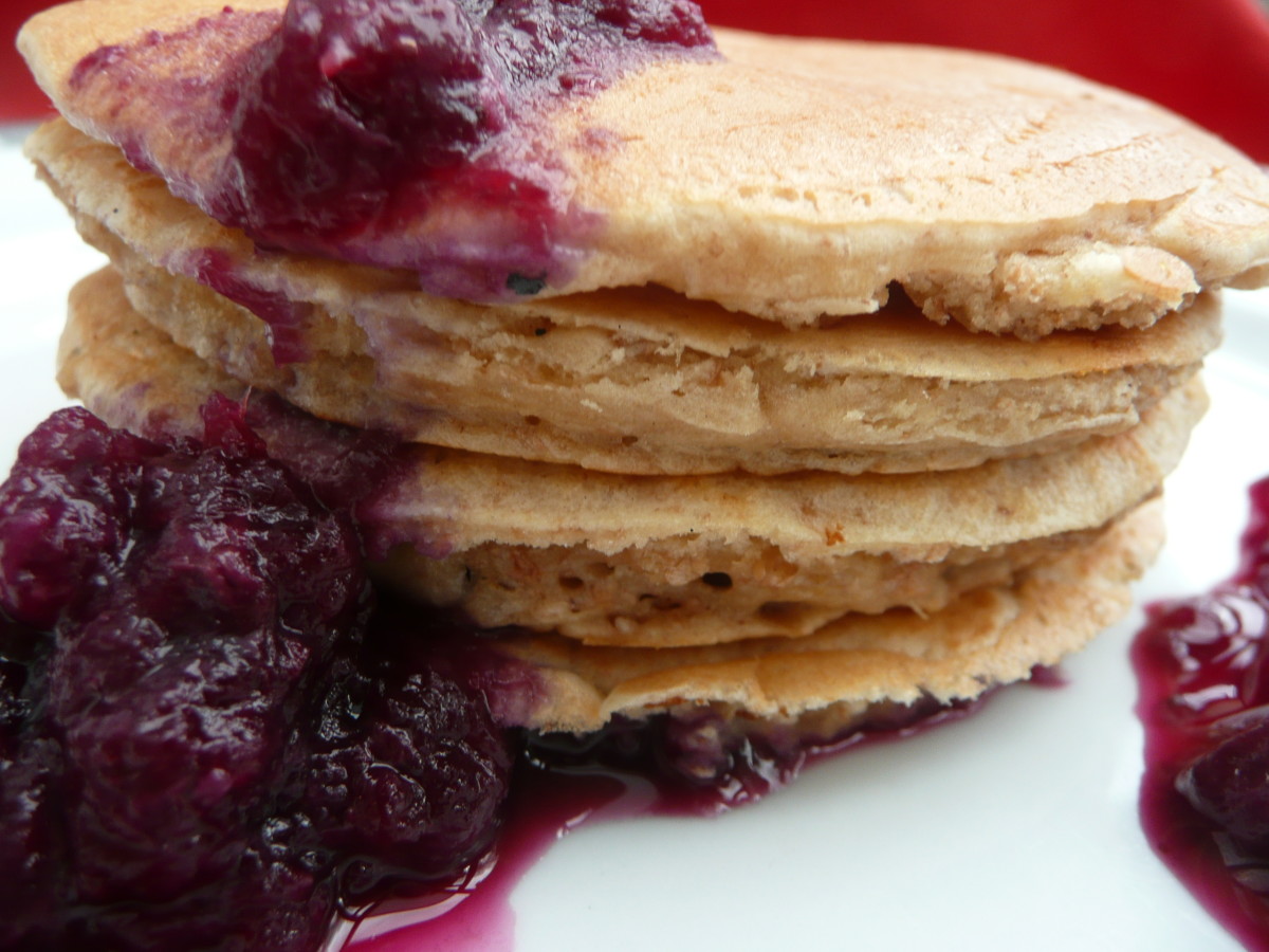 A stack of Scotch pancakes topped with jam.