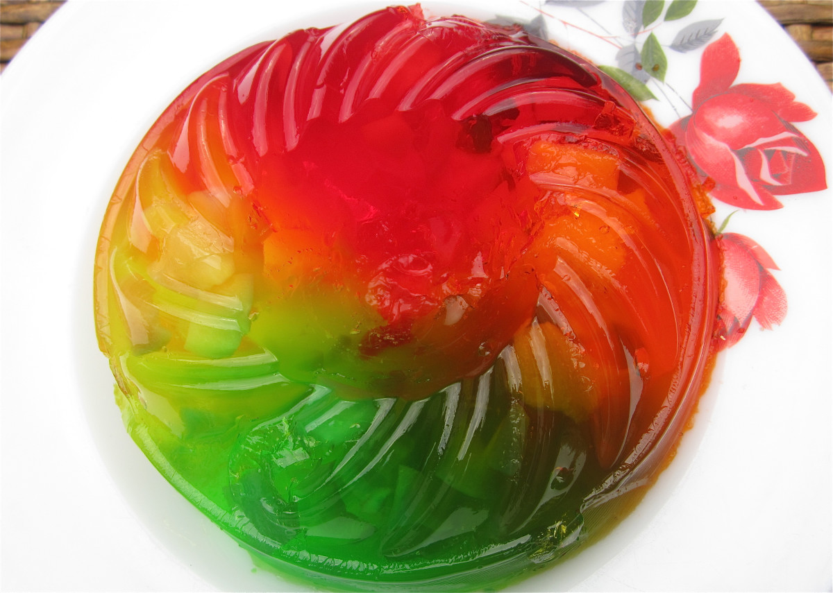 Rainbow Jell-O, or jelly, made of colored and flavored gelatin encasing fruit
