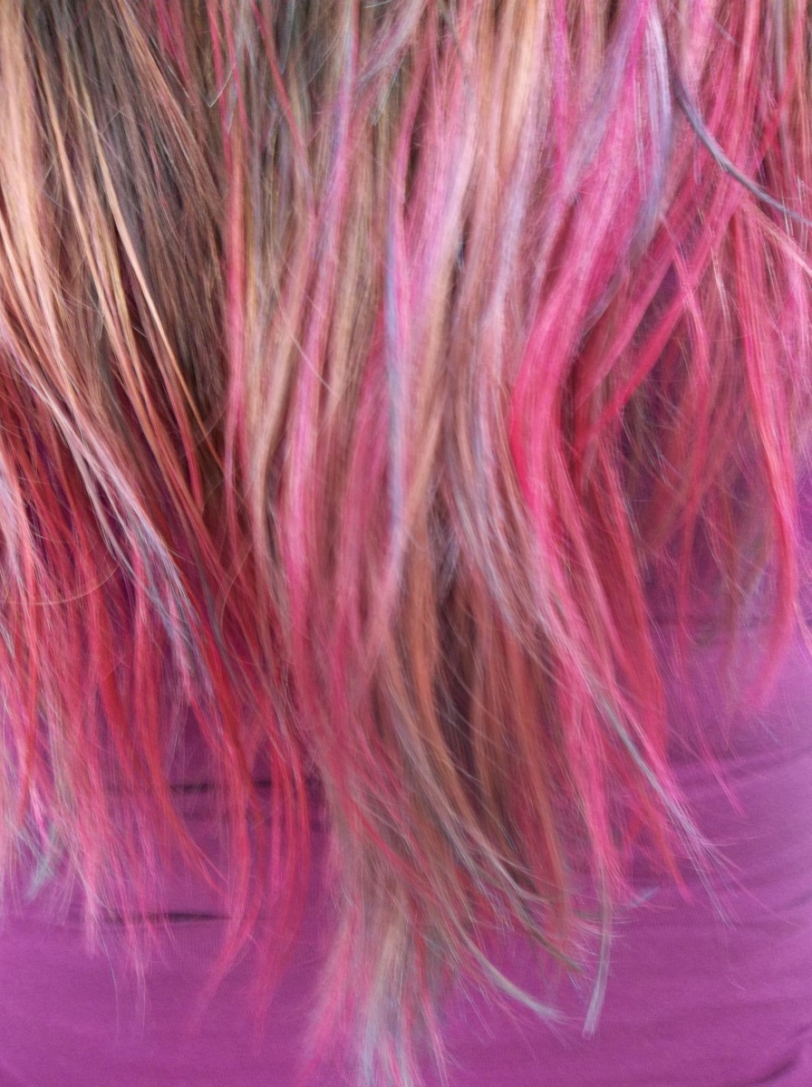 Hair is a great way to express yourself. This style has a combination of pink and teal dye on the tips.