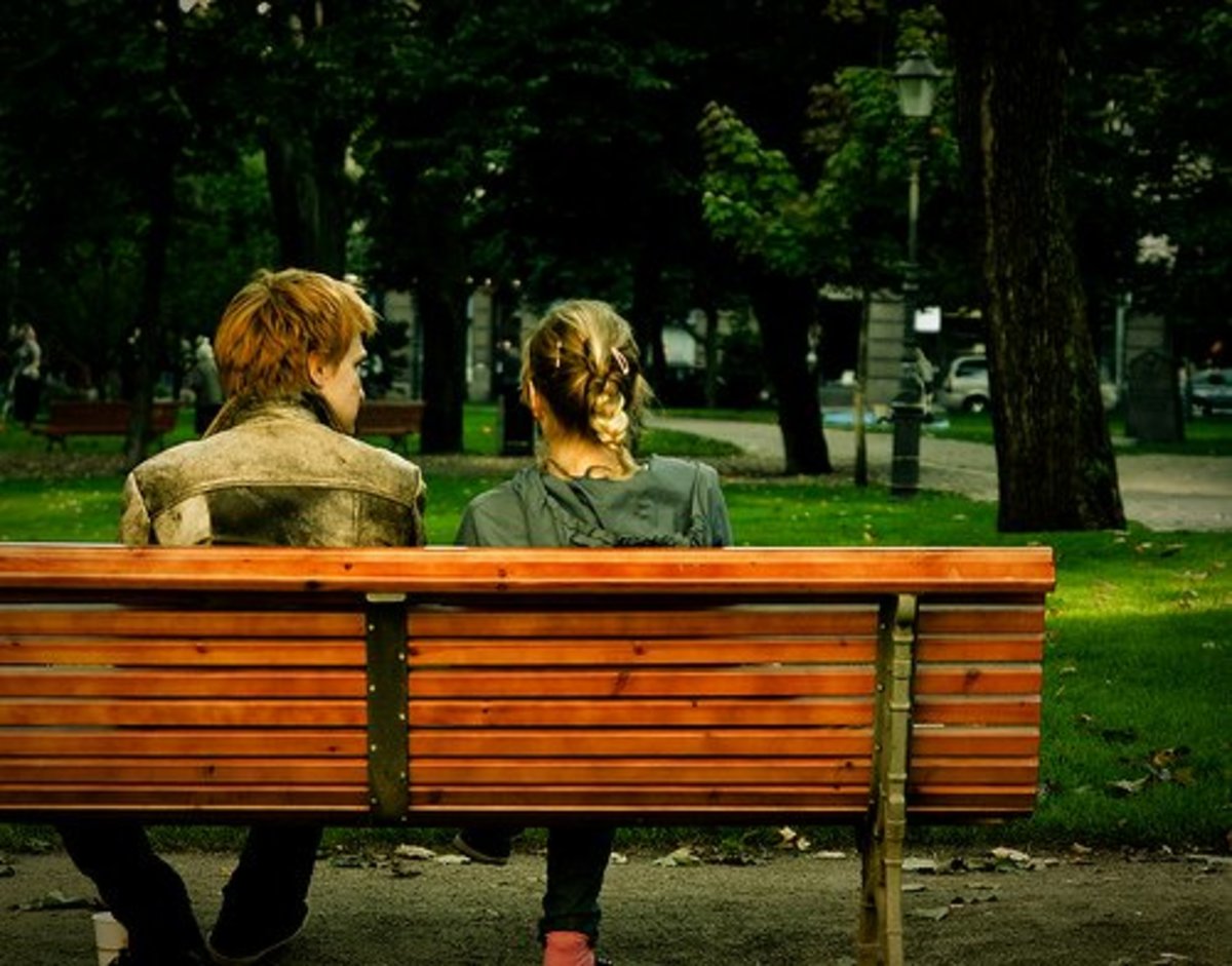 Young man and woman on the bench.