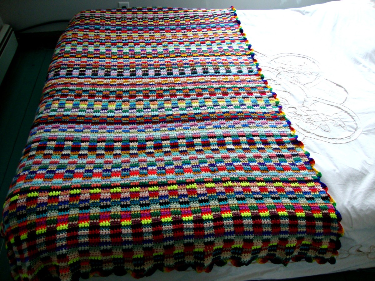 A colorful afghan made entirely from leftover yarn—what a practical way to use up yarn scraps.
