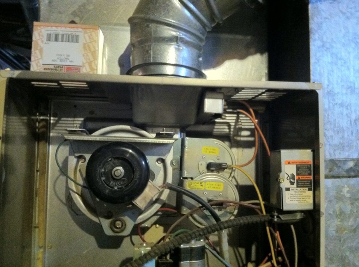 Inducer Fan/Motor (bottom left) Pressure Switch (right of inducer) and Chimney Connection/Inducer Housing (top center)