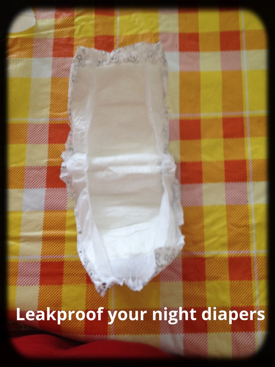 Cut sides off of smaller diaper.