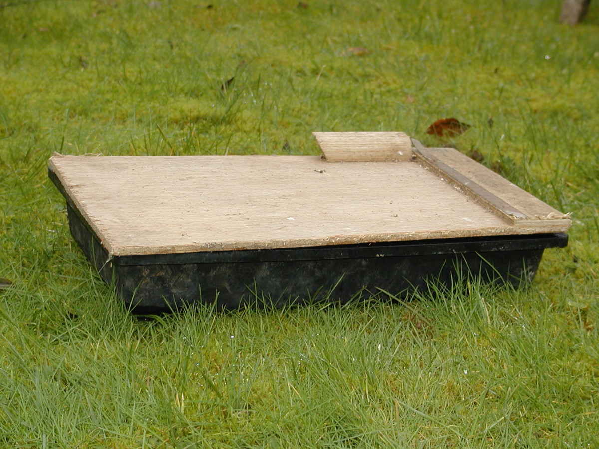 Cover the seed tray. I used a scrap piece of thin plywood which worked nicely.