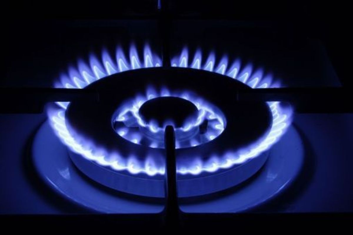 A gas stove uses fuel to heat and cook food. 