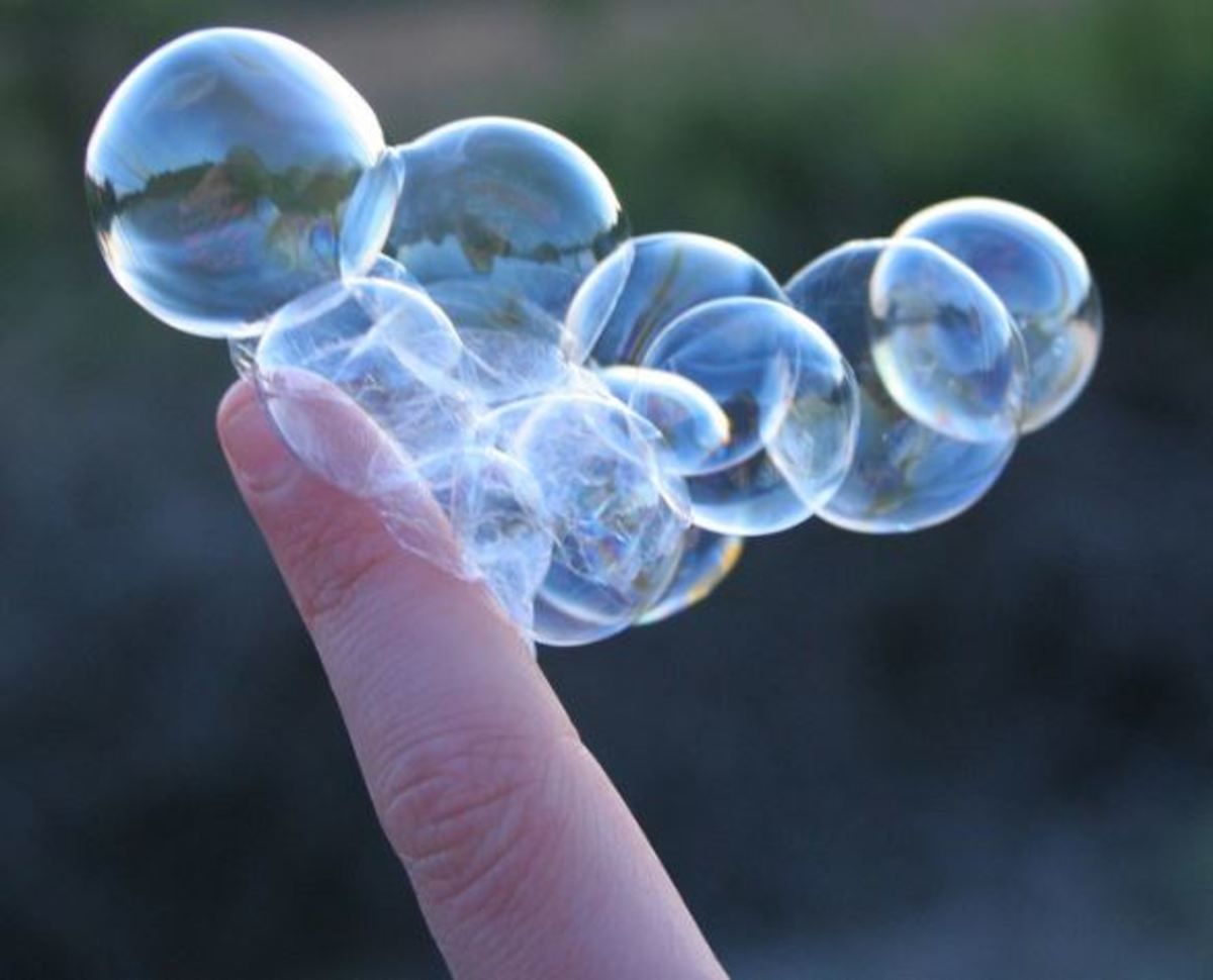 A cluster of bubbles on a person's finger. The writing site Bubblews was focused on connections.
