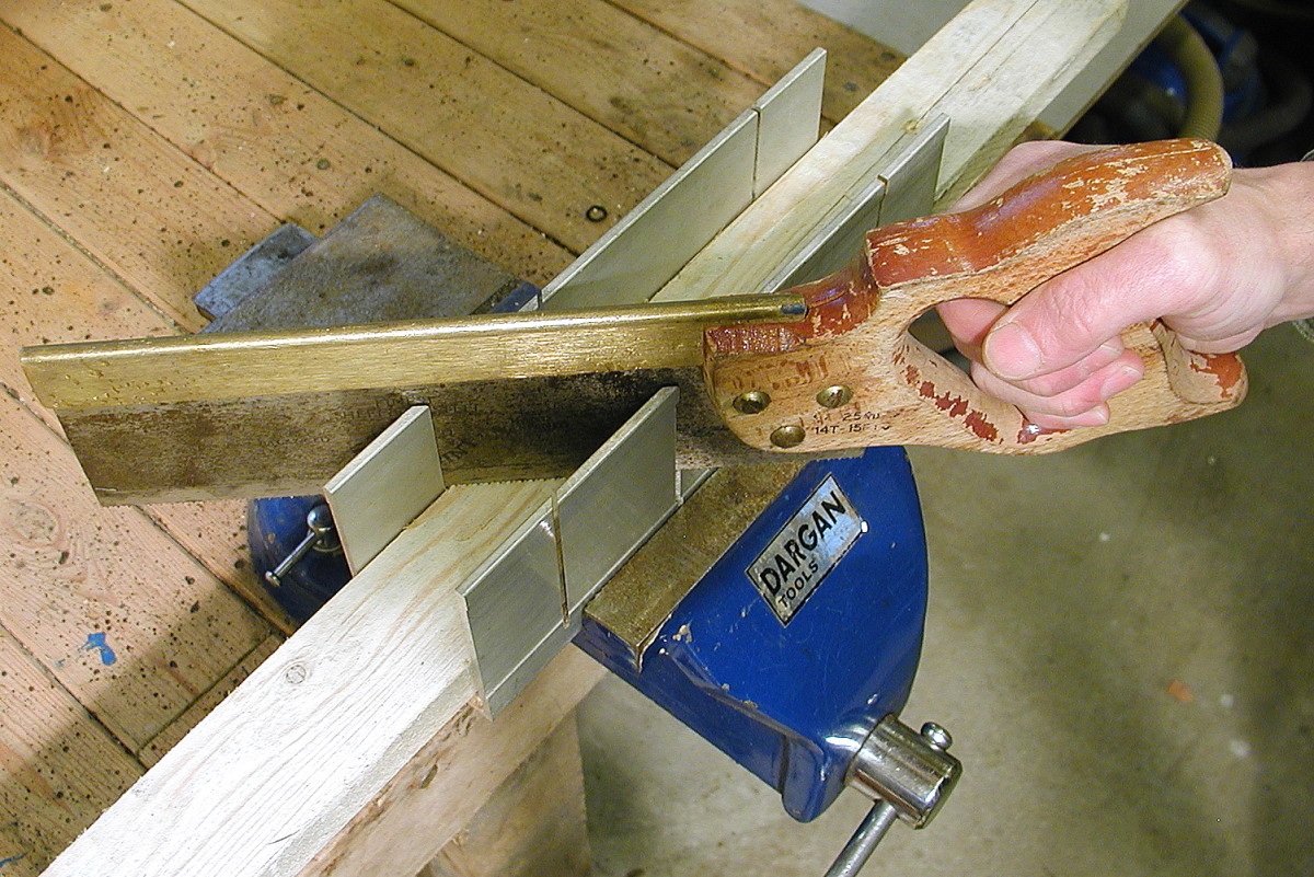 The slots in metal miter boxes don't wear away as quick from contact with the teeth of a saw