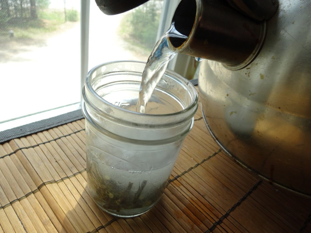 Pour boiling water over the twigs in the glass jar.