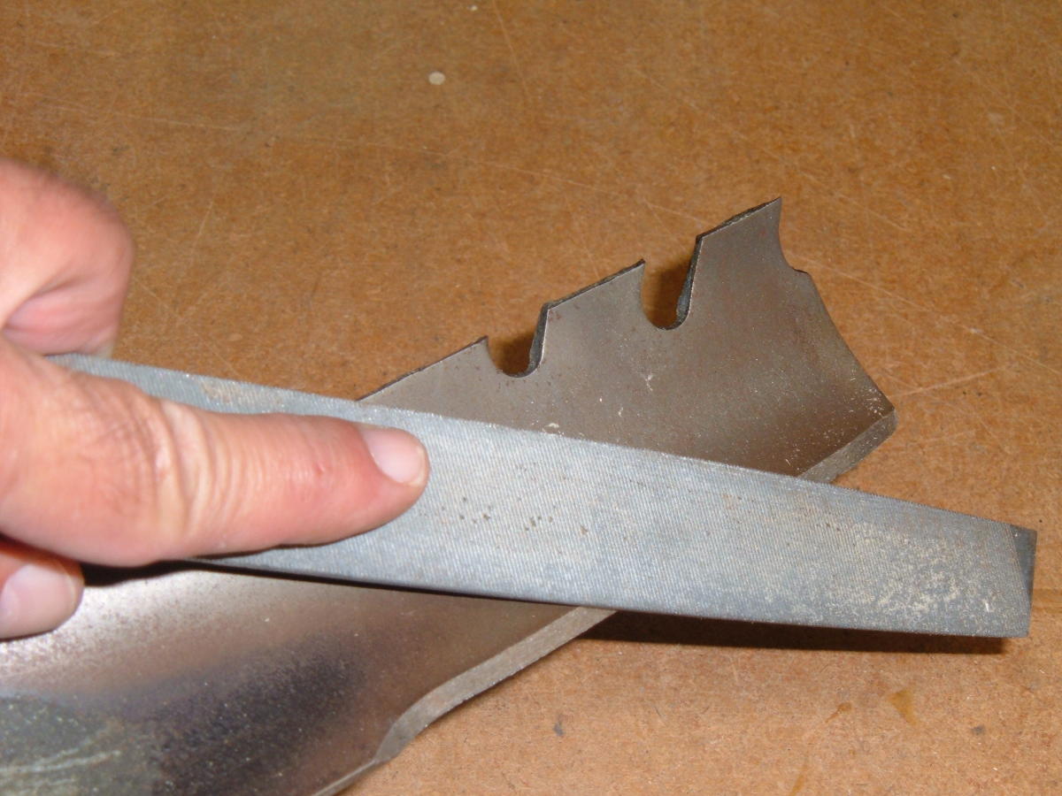 Use a file to sharpen a dull mower blade