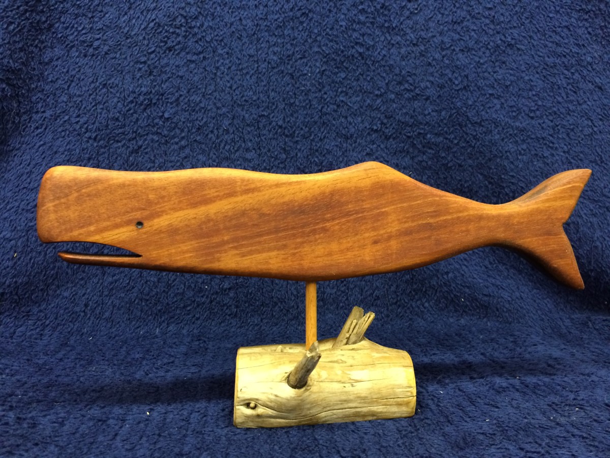 Wooden whale on a driftwood stand