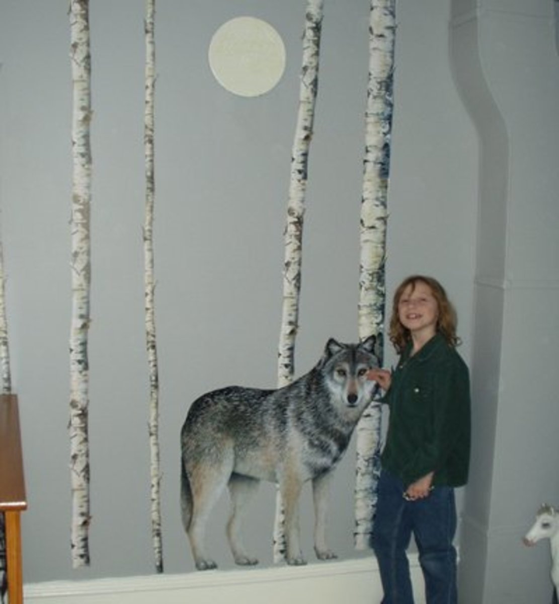 This life-sized wolf is really a wall mural. See how big he is and how real it looks? I think it would be scary to have a wolf in your room, but Lacey thinks he keeps her safe.