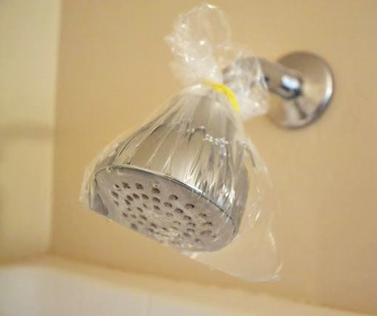 Wrap a plastic bag filled with white vinegar around the showerhead and fasten with a thick rubber band or bag tie.