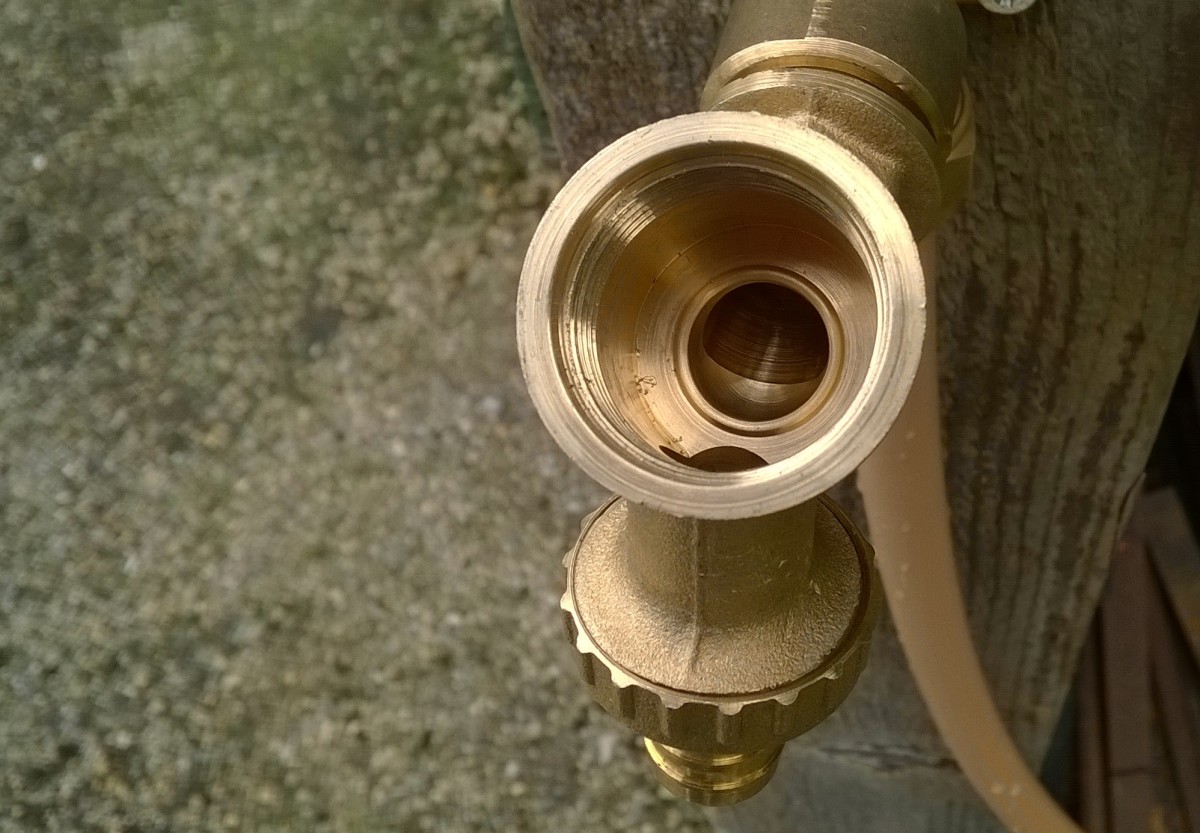 The washer seals against the rim of the hole inside the spigot (called the valve seat)