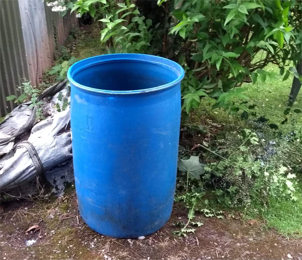 It's a good idea to have a small barrel like this one filled with water when mixing concrete.