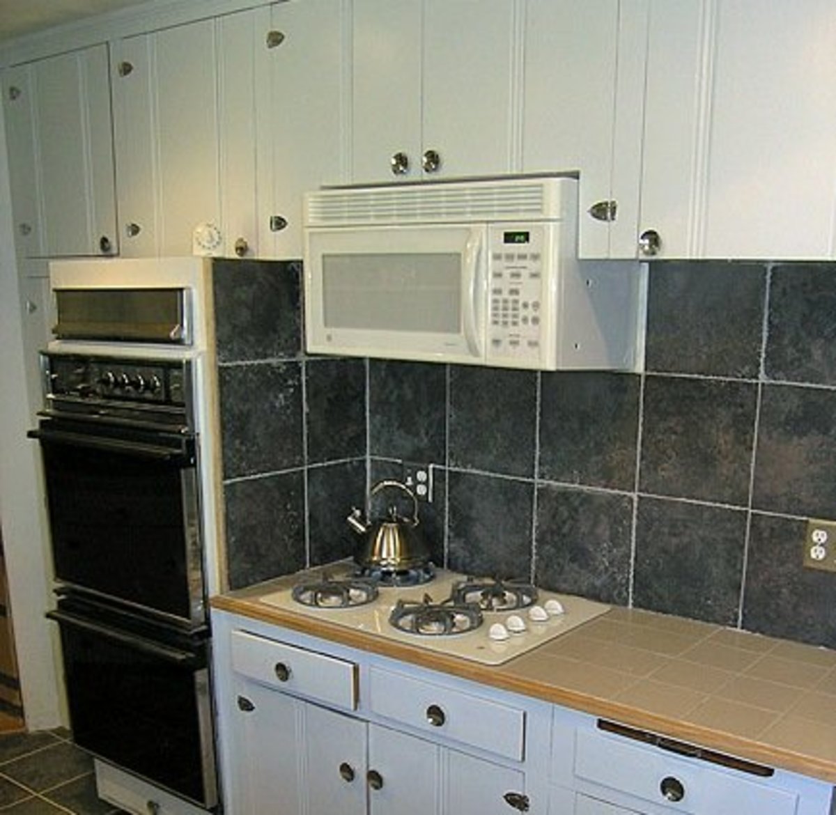 Microwave above the stove top.