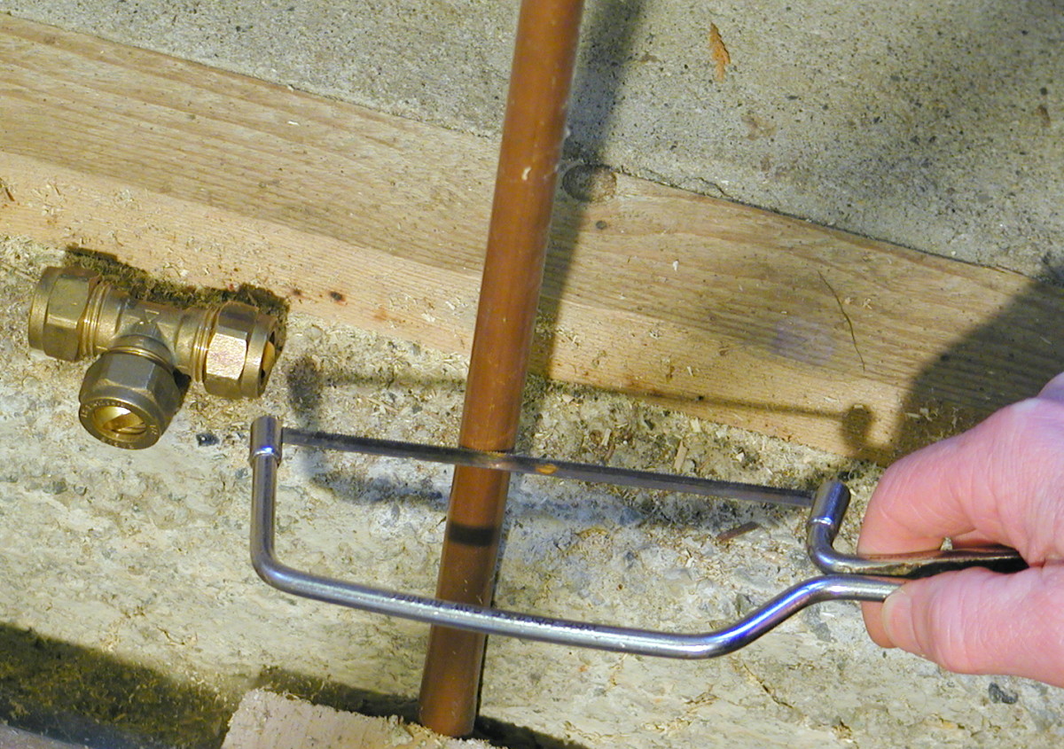Existing plumbing may need to be cut with a hacksaw if there isn't enough clearance to use a pipe cutter.