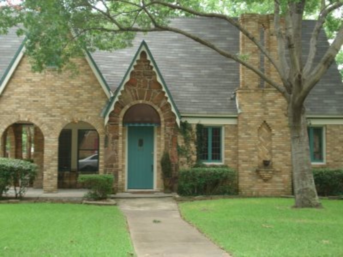 Home with a turquoise teal front door and window trim.