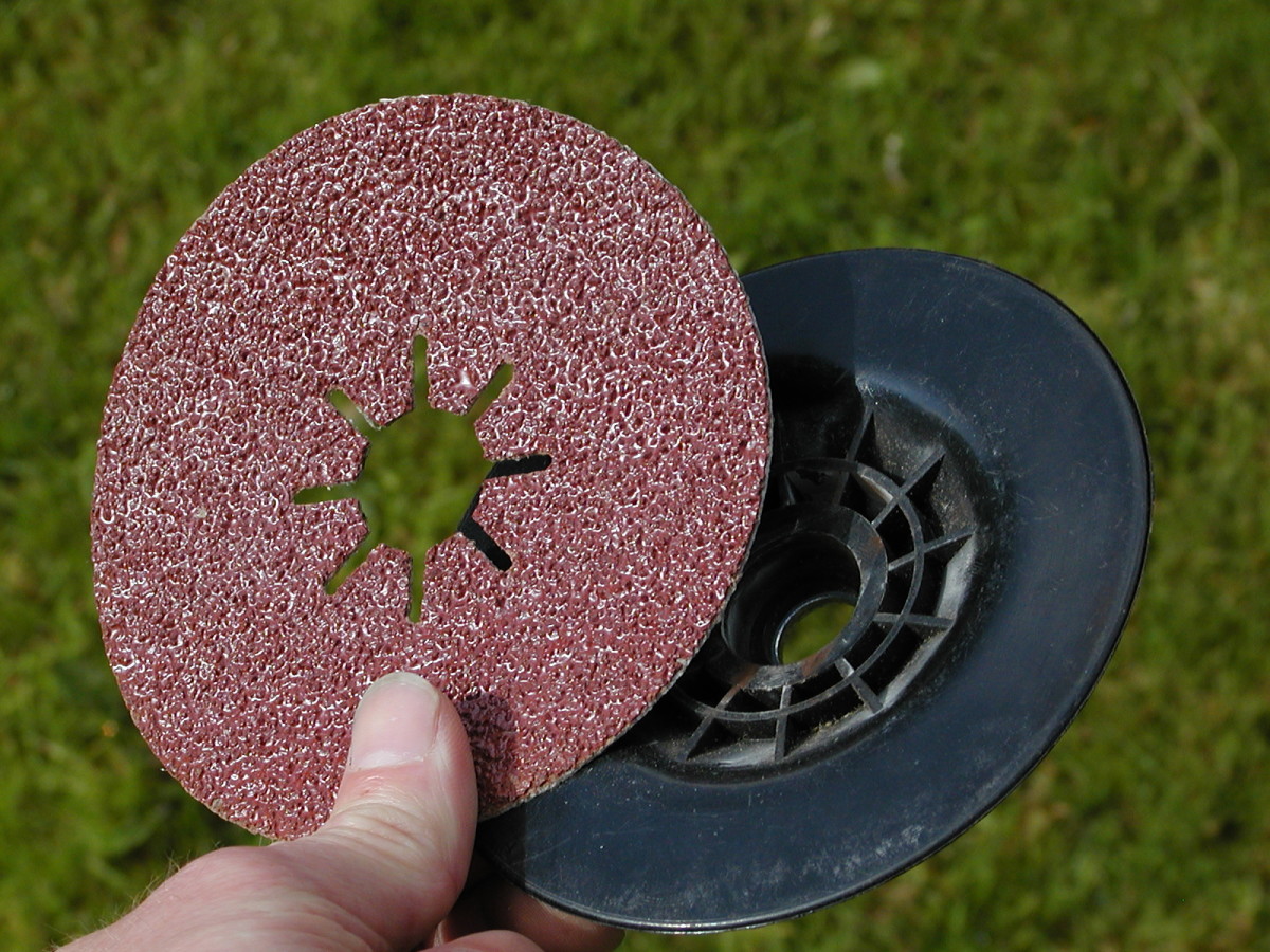 Sanding disk and backing pad for an angle grinder.