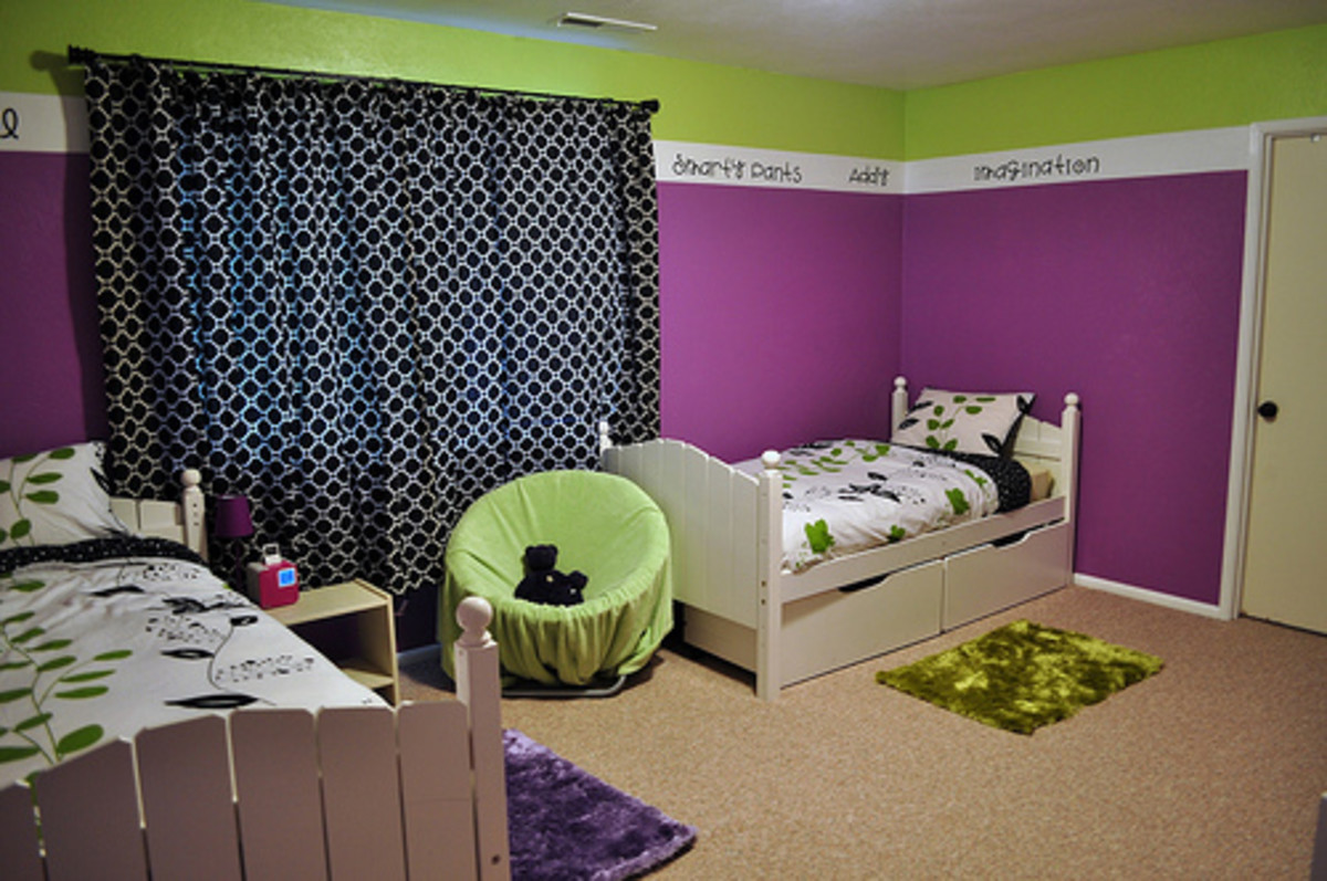 Black print curtains and a stripe of lime green around the top of the room help break up all the bright purple.