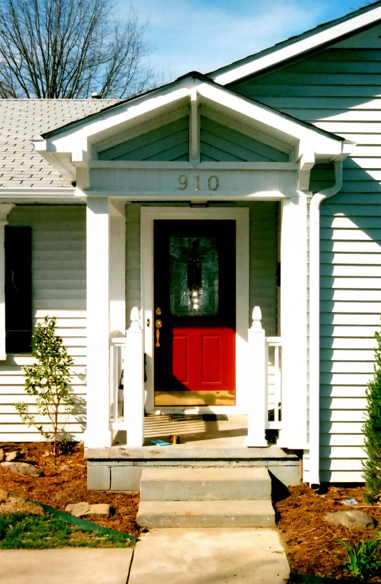 A pop of red makes this front door a focal point on a small cottage.