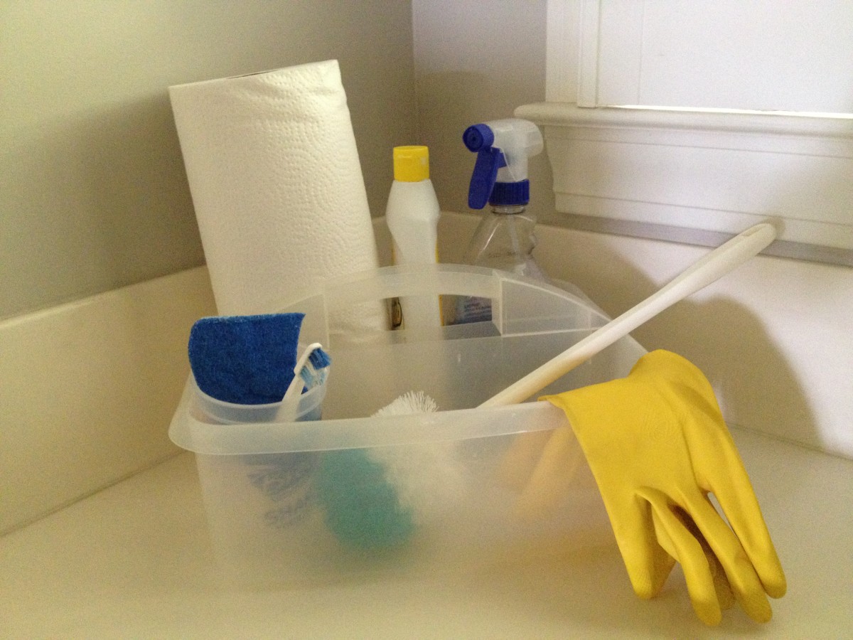 A cleaning caddy filled with cleaning supplies for the bathroom