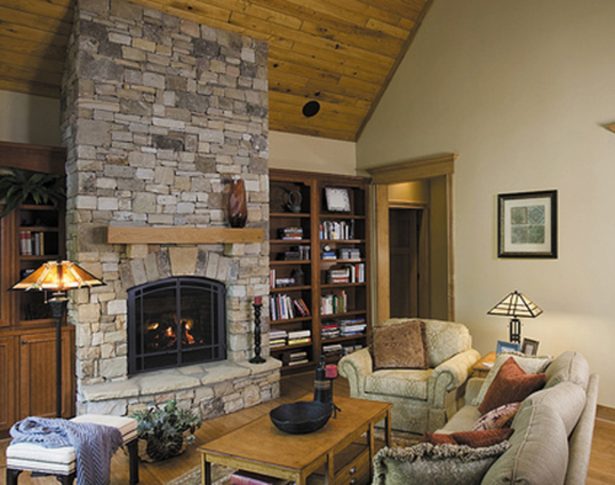 A stone fireplace makes a statement in rustic cottage design.