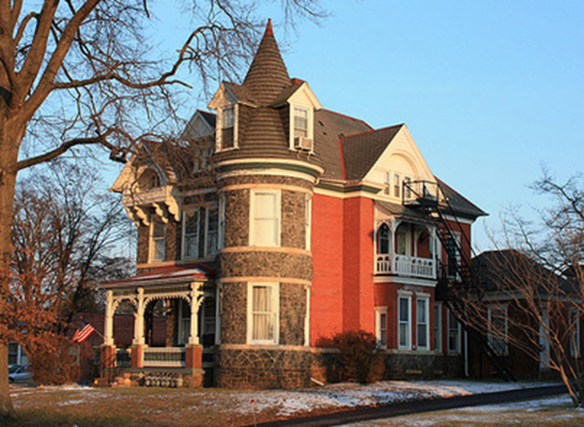 A Victorian with a castle-like tower and exterior stone accents.