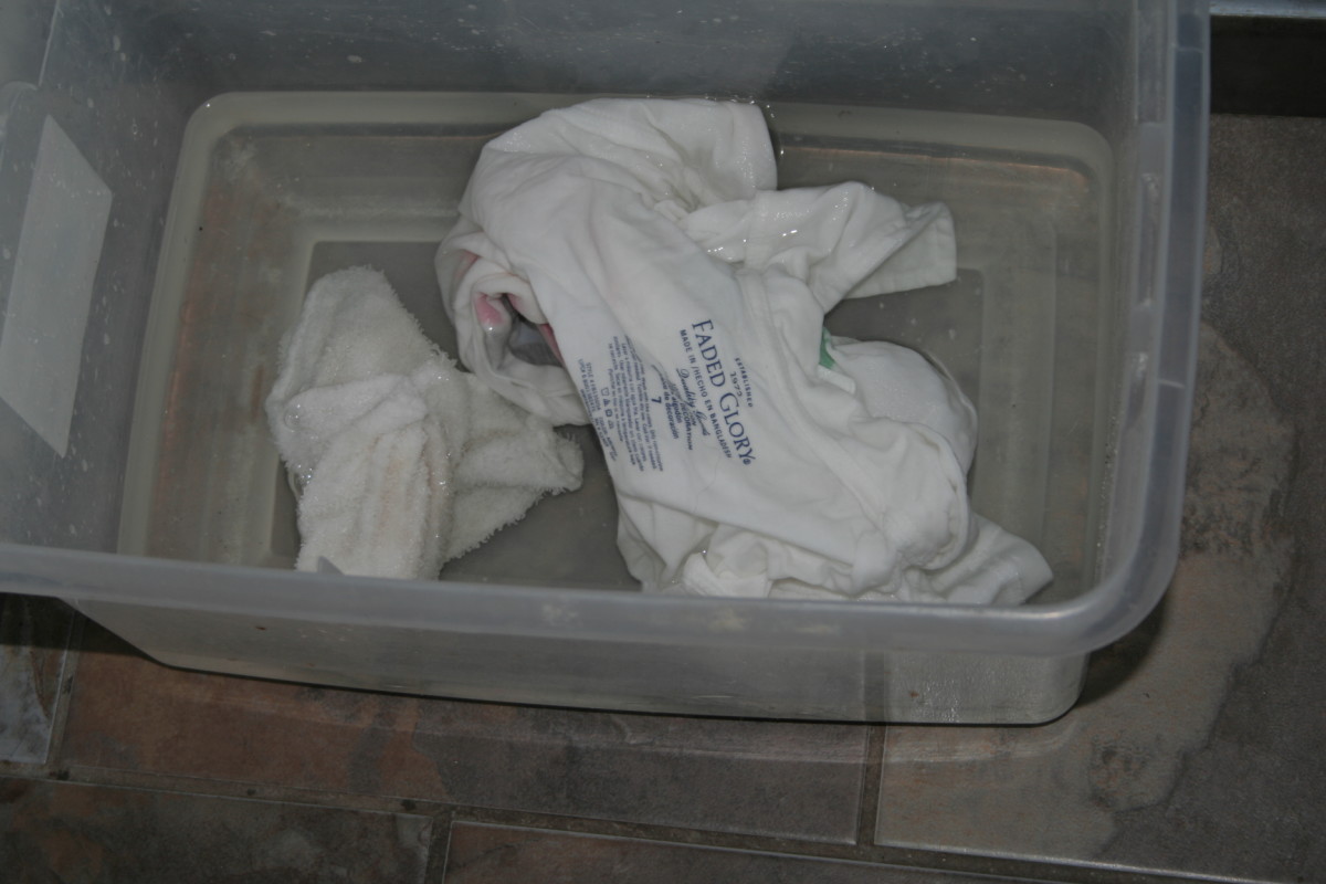 Add bleach, detergent, and water to the bin of white clothes.