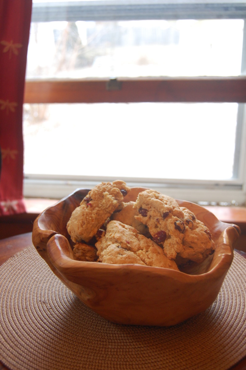 Rustic wooden bowl filled with scones.