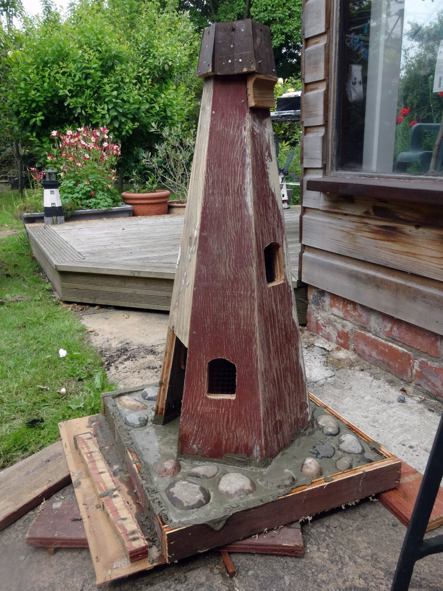 Base of the windmill set in concrete to prevent it being blown over by the wind.