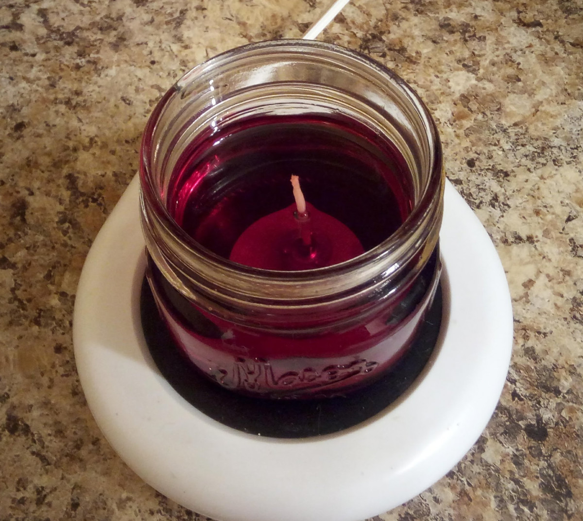Scented candle melted on coffee warmer