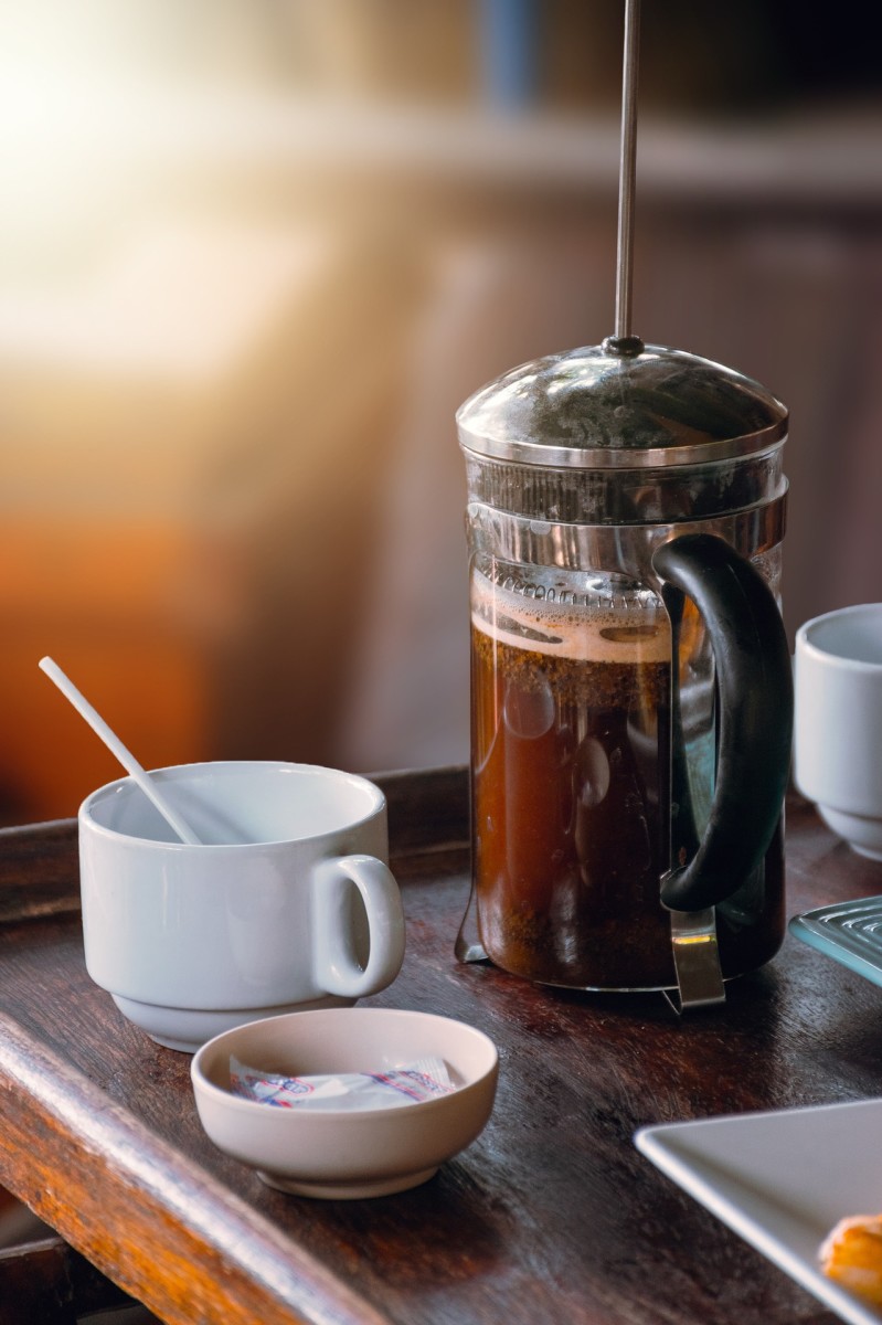 Make a simple coffee bar with a french press, some gourmet coffee, sugar, whitener and an electric kettle.