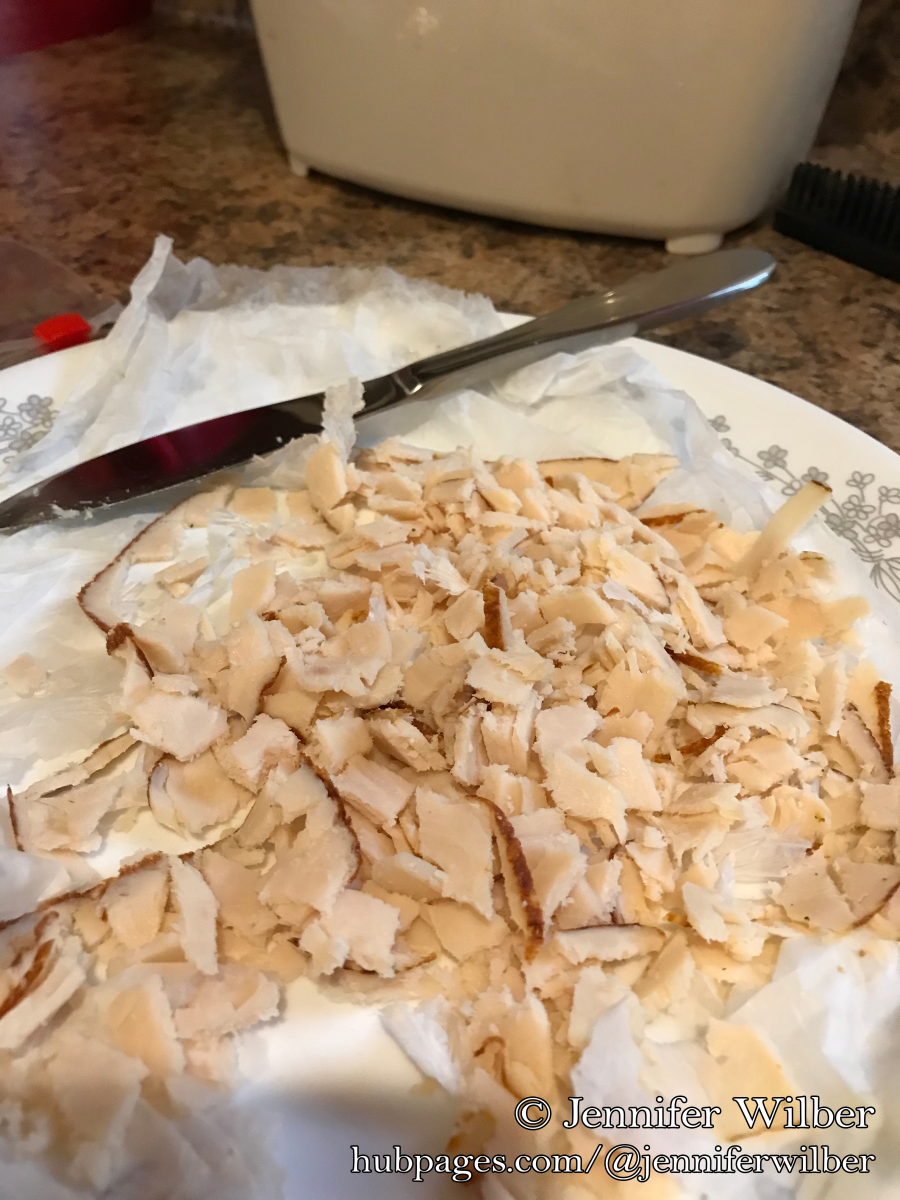 First I cut up the expired chicken lunch meat into small pieces, which will more easily break up inside the composting system.