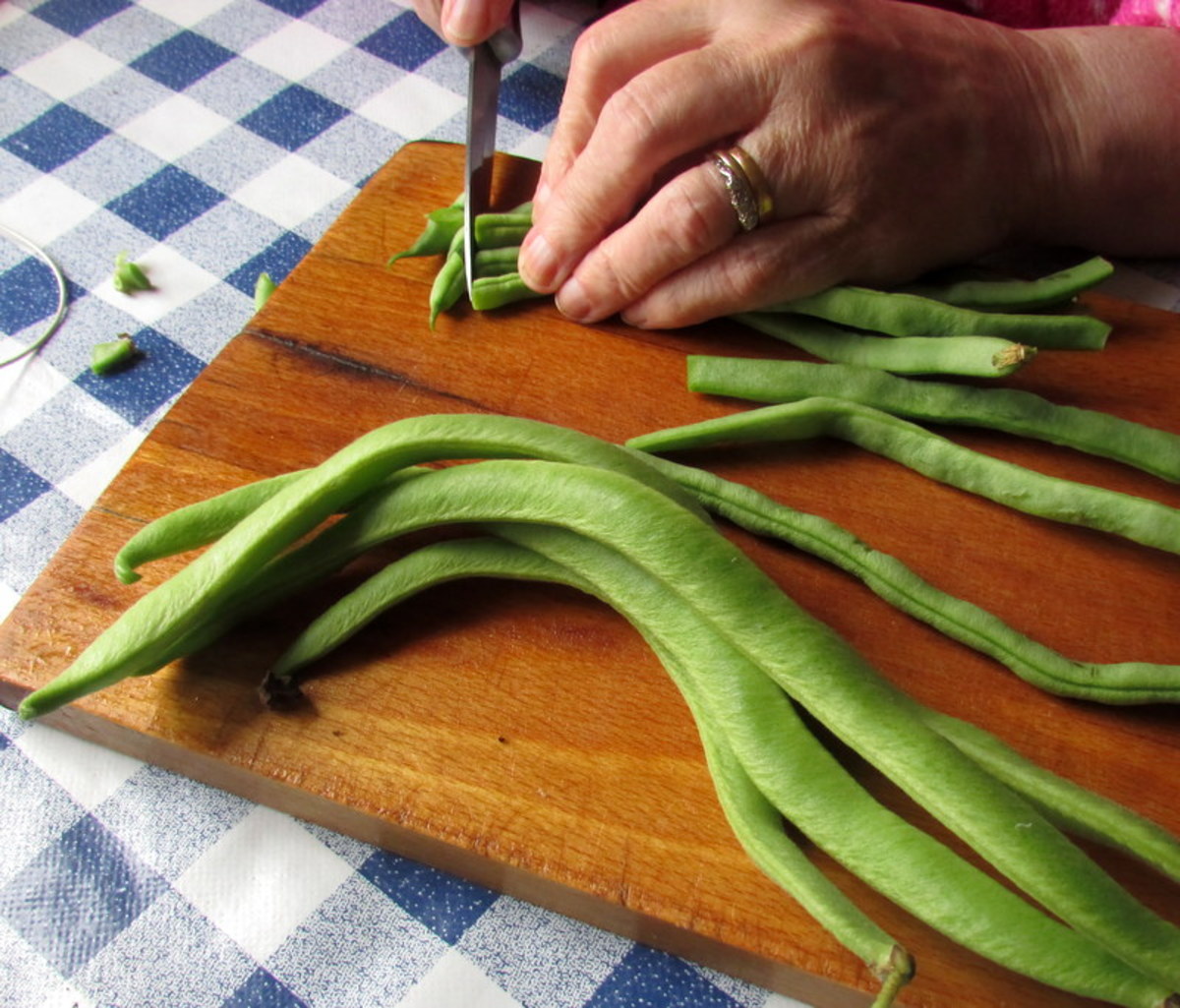 Preparing runner beans for freezing.