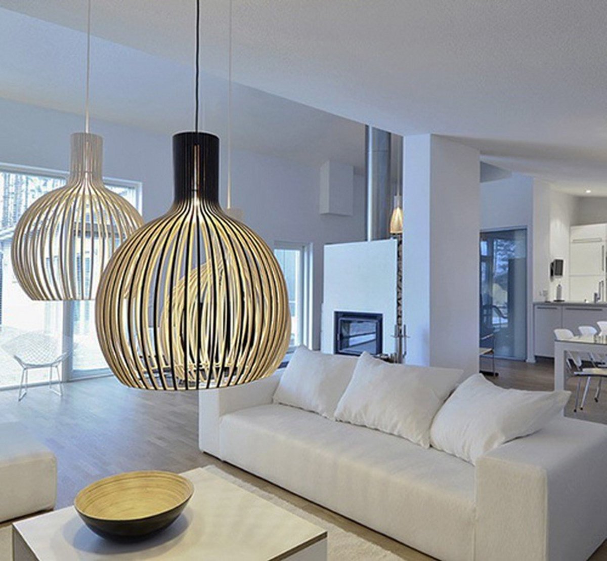 Large pendants over a coffee table add ambient lighting to a seating area.