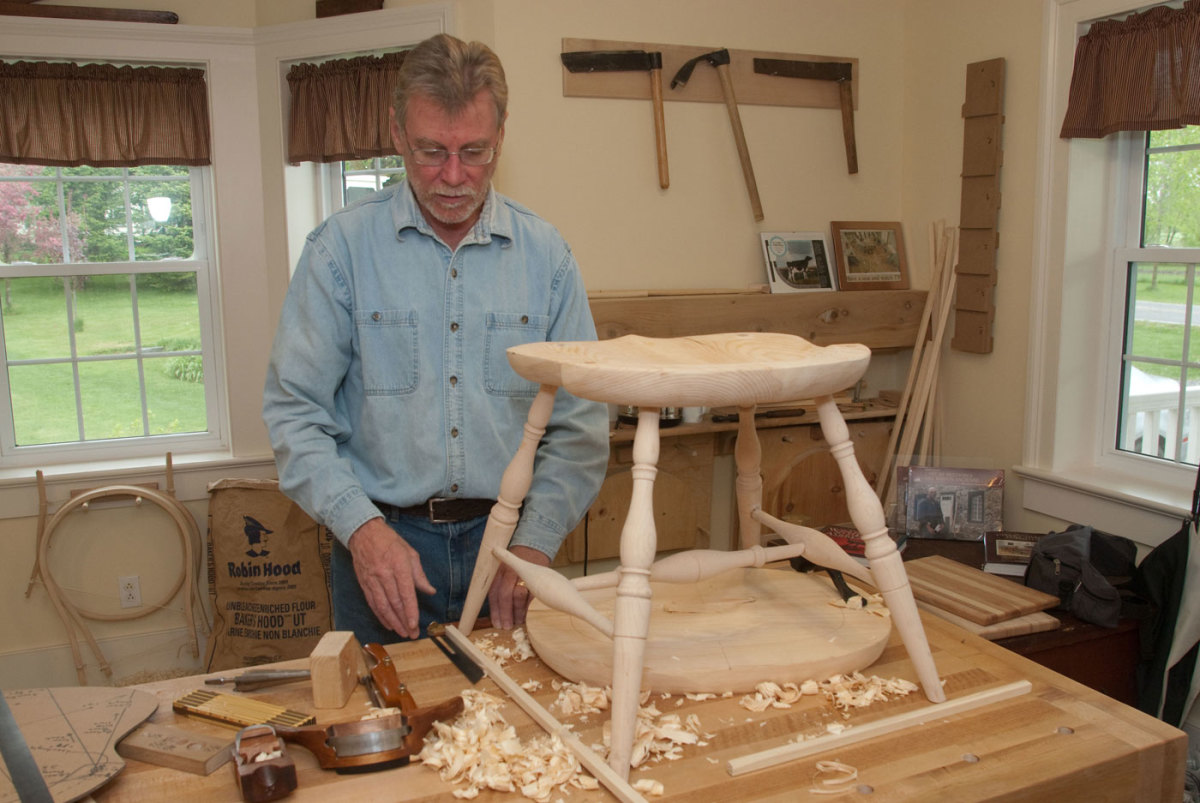 "Legging up" a continuous arm chair seat.