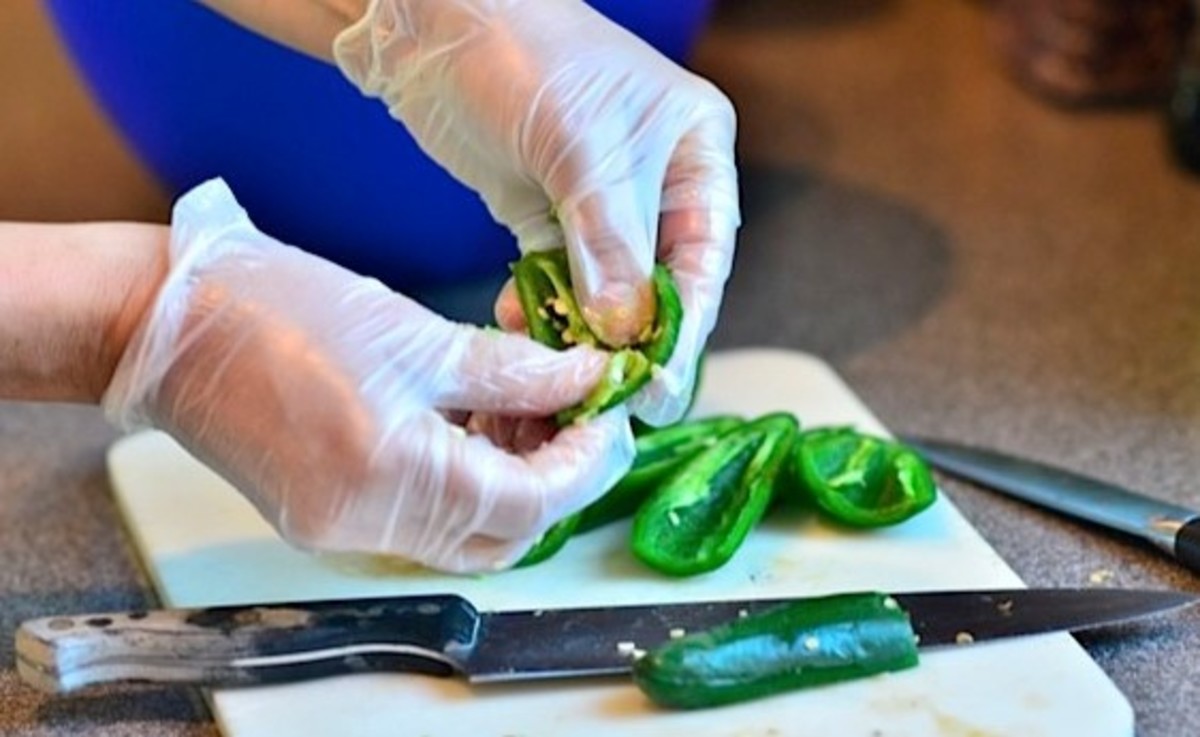 Wearing gloves while cutting and handling peppers can help prevent you from accidentally getting capsaicin in sensitive areas such as your eyes.