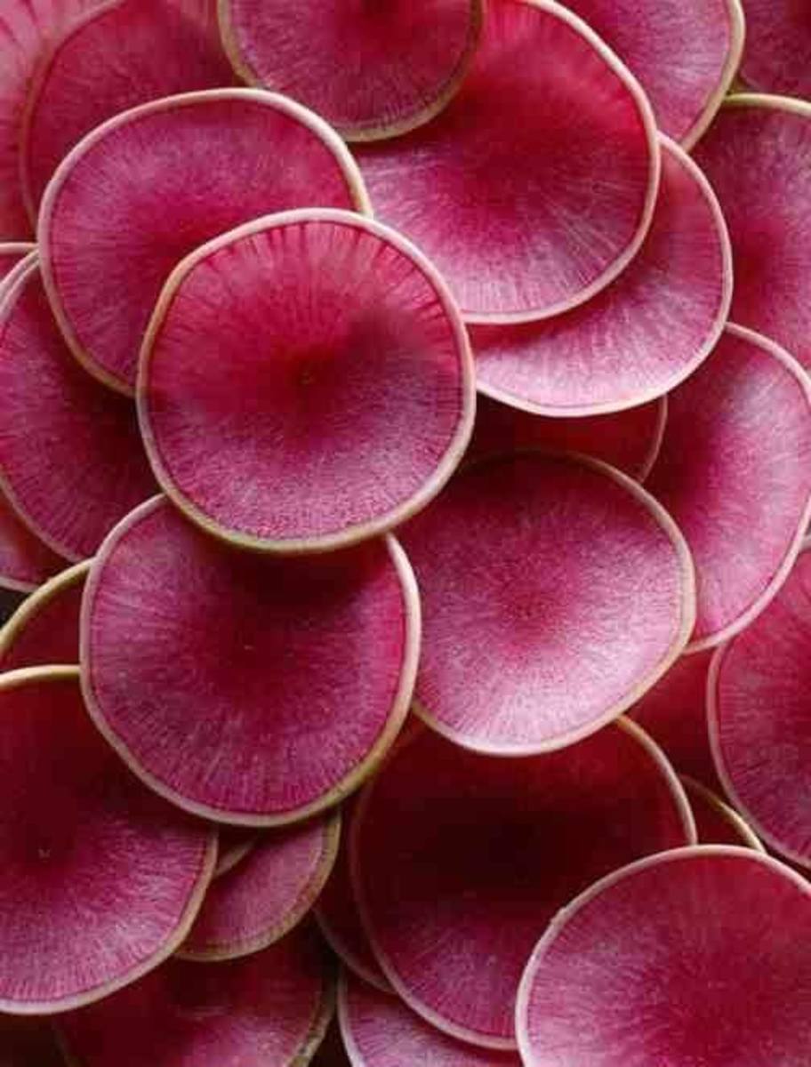 Thinly sliced watermelon radishes. Not only would they be beautiful in a salad, their taste is wonderful as well. 