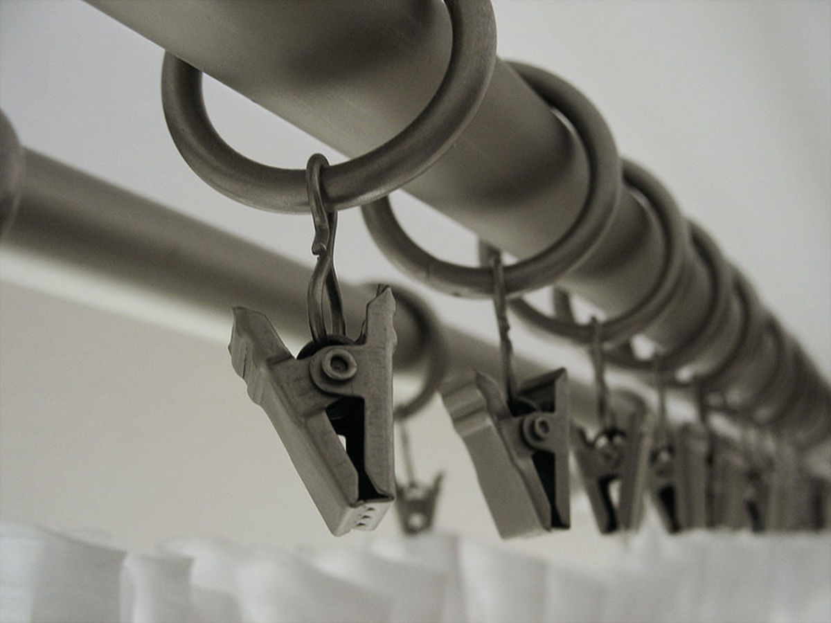 Double curtain rods hang sheers beneath  decorative curtains to create privacy.