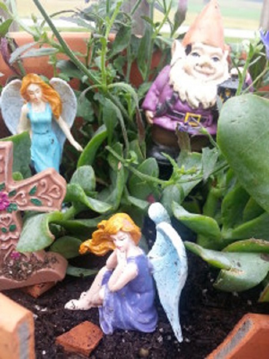 Some fairy and gnome figurines turn the garden into a whimsical habitat.