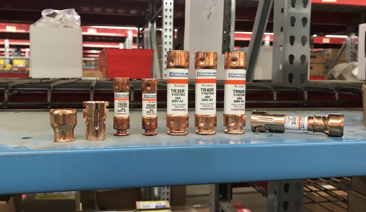 Here you see fuses rated for different amps as well as the differences in physical size and how fuse reducers (far left and right) can help fit new smaller fuses to old disconnects.