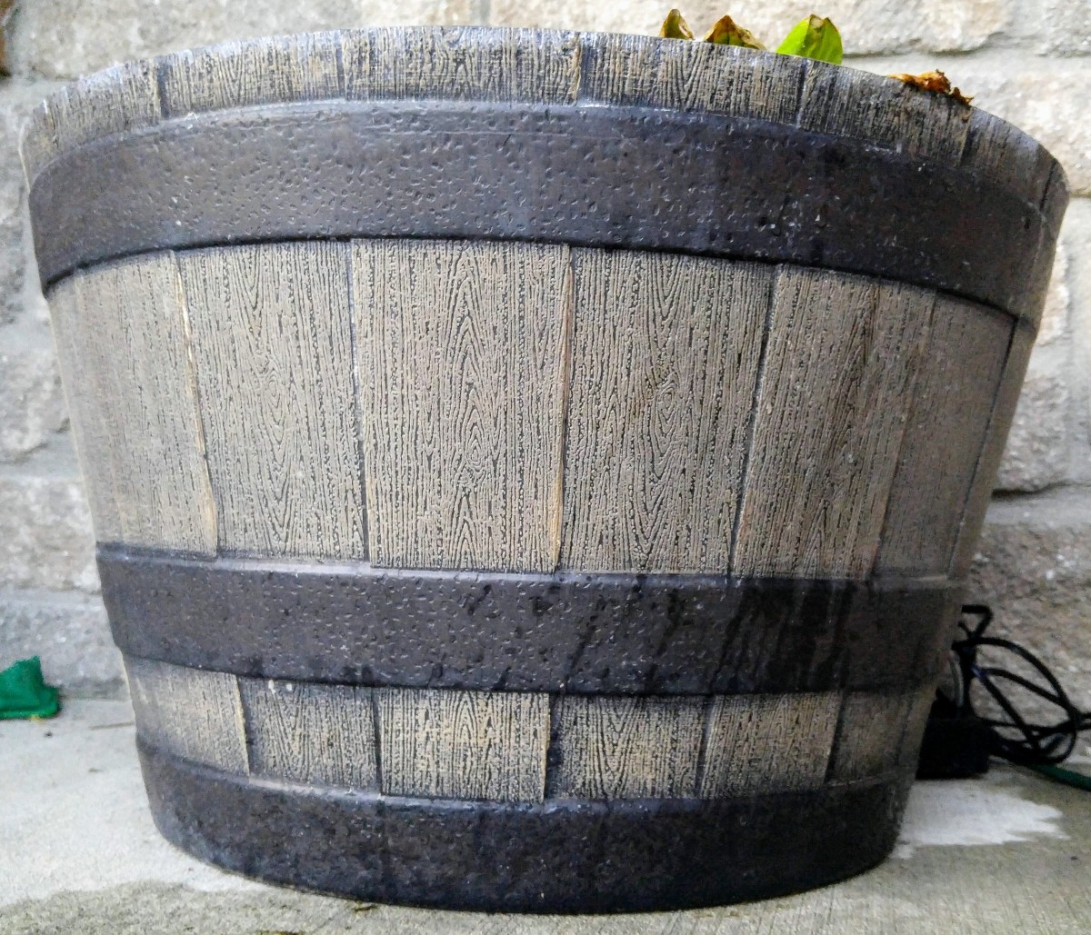 This half whiskey barrel is made from resin.