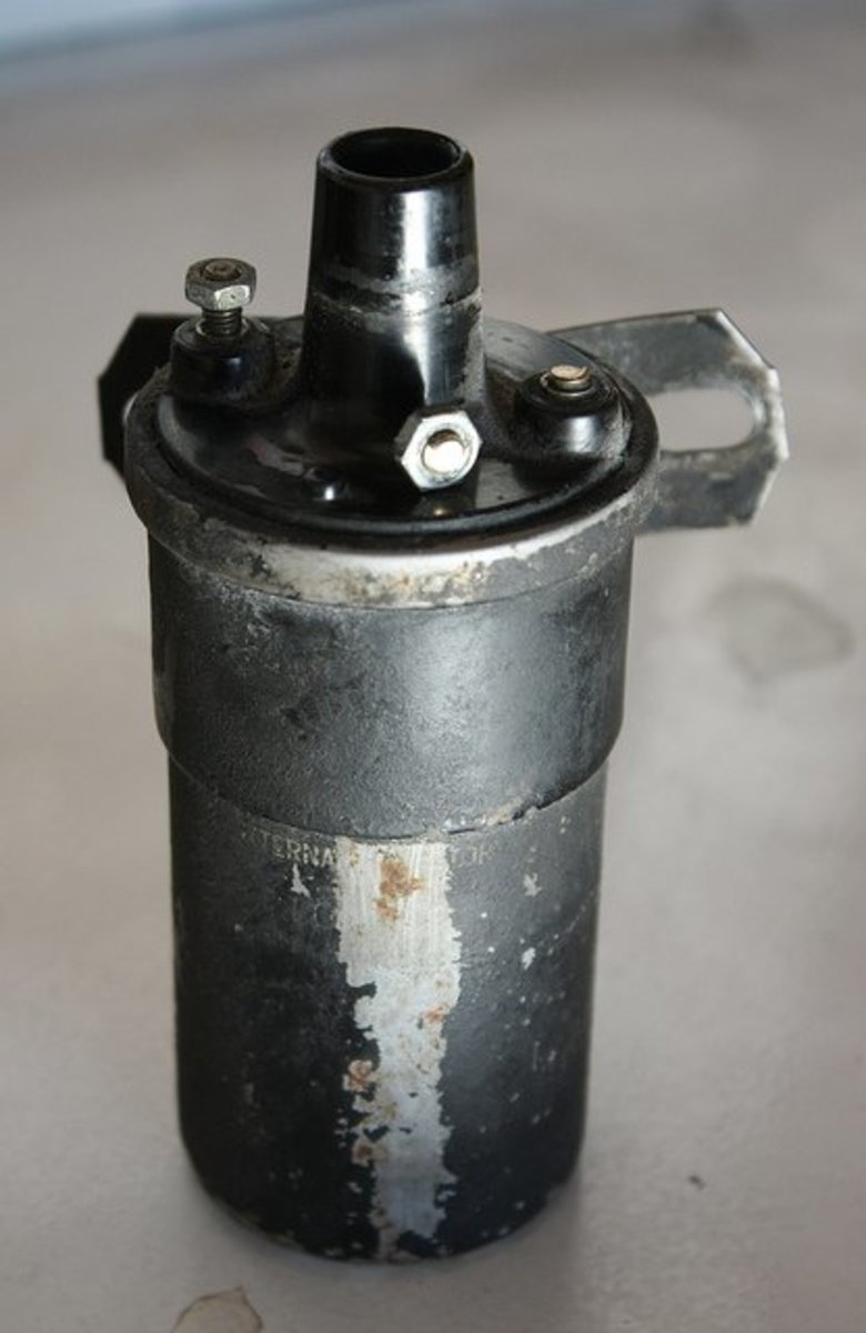A conventional ignition coil with a broken primary terminal.