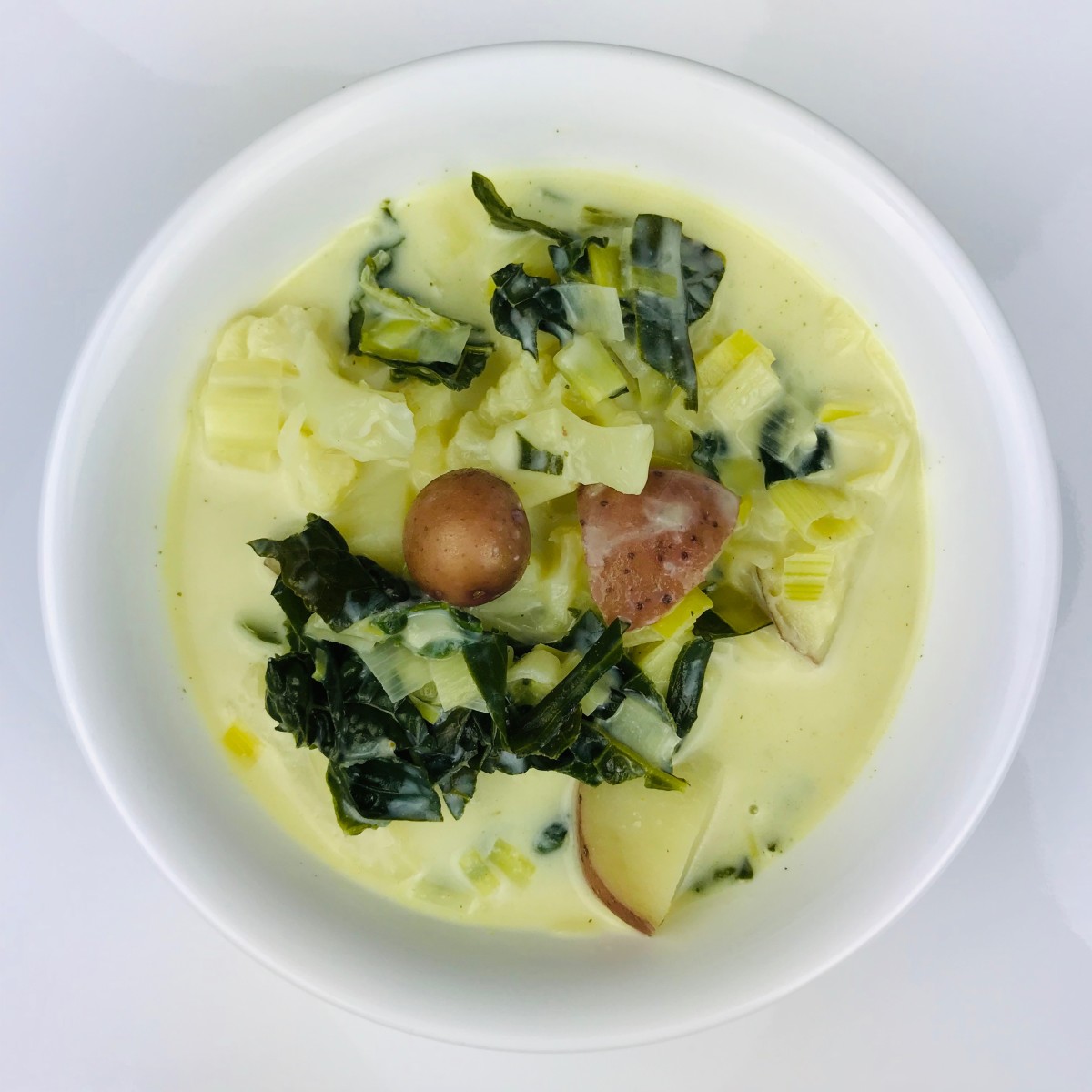 Leek and potato soup with kale and cauliflower.