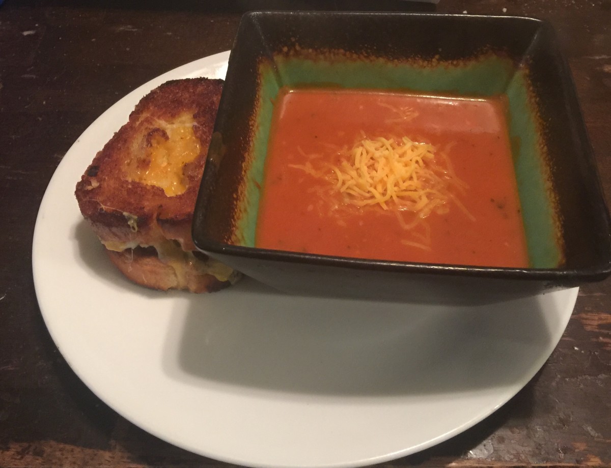 Rustic tomato soup served with grilled cheese.