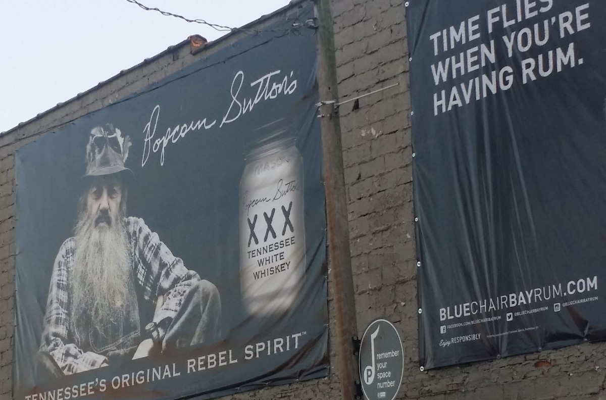 Signs advertising Tennessee's history in the alcohol industry. The building is located in downtown Nashville.