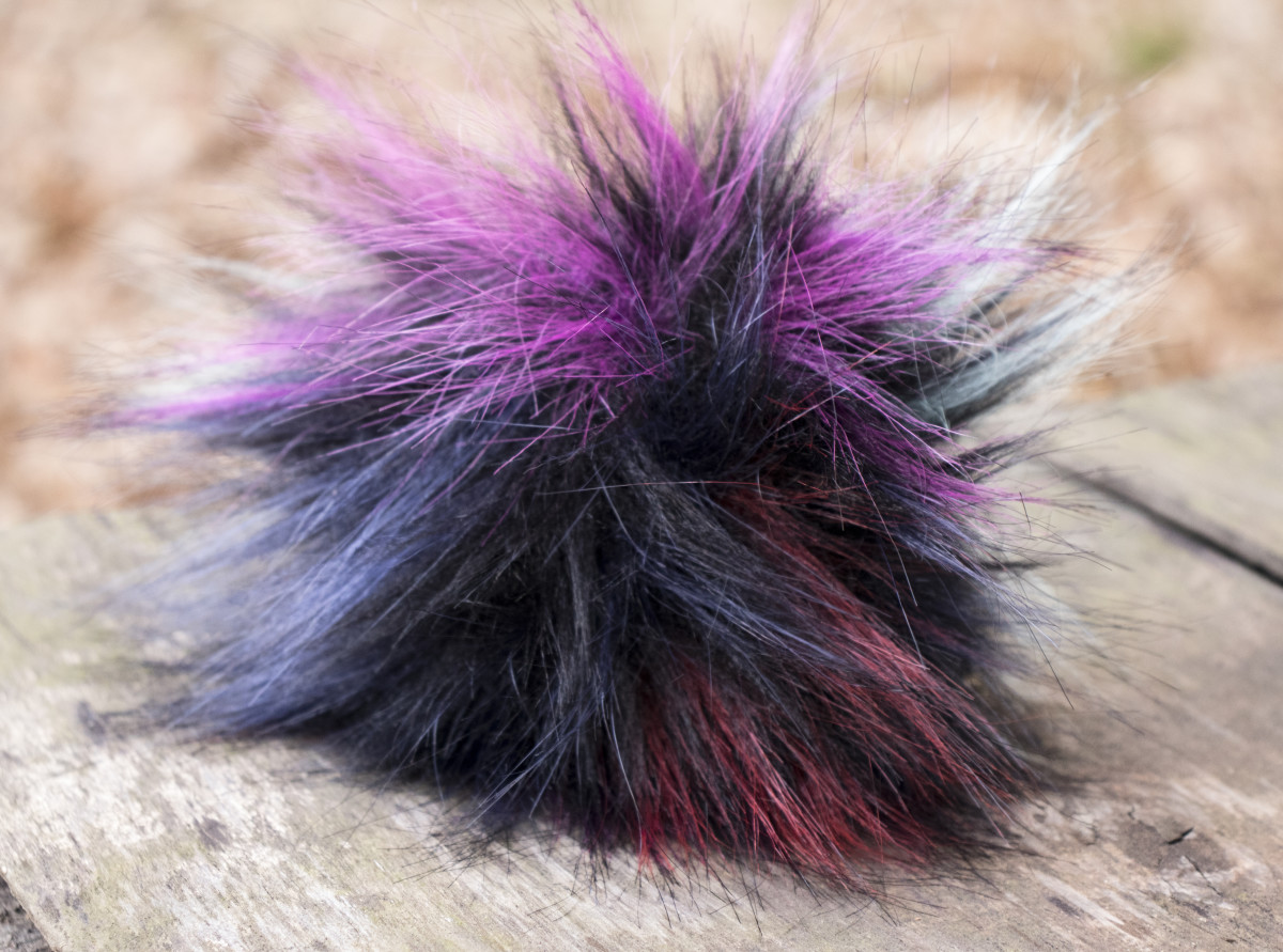 A multi-colored, long hair Tribble.