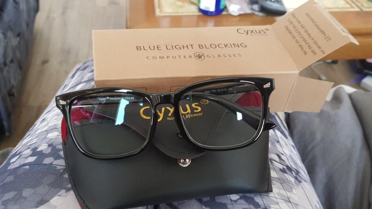 The Cyxus blue light blocking glasses, with the included glasses case, and the box that they arrived in.