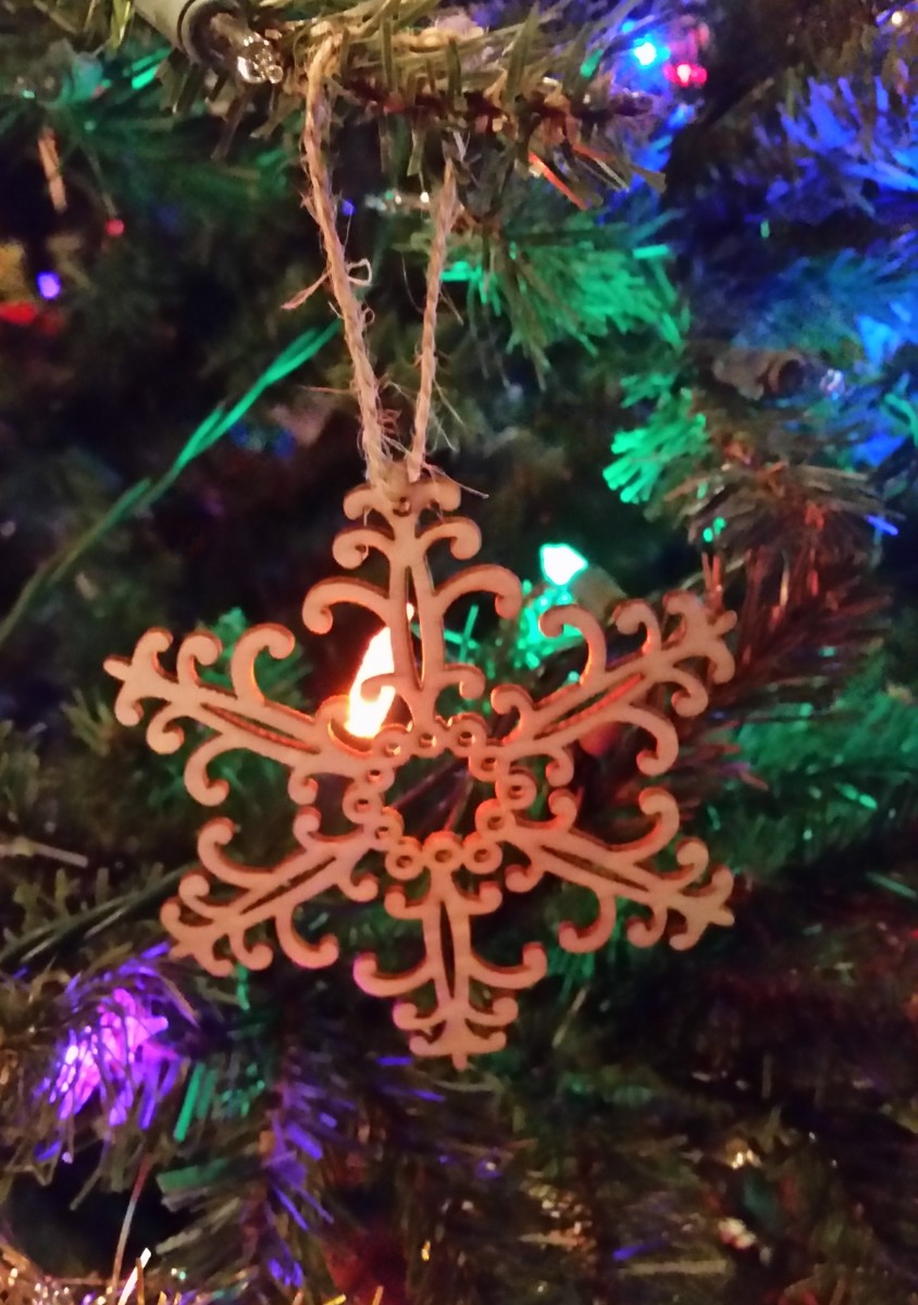 This is the ornament given to my family members a few years ago. It's made of wood that's been laser cut into intricate designs. 